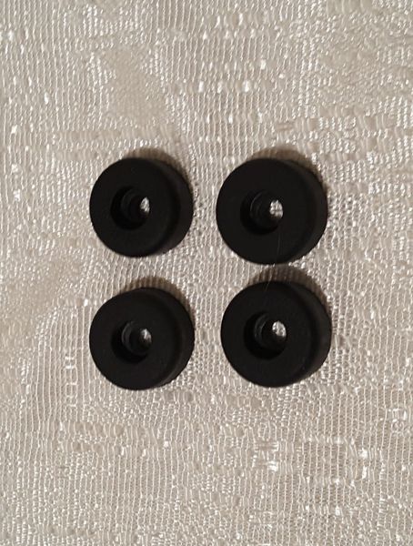 Four black circular parts