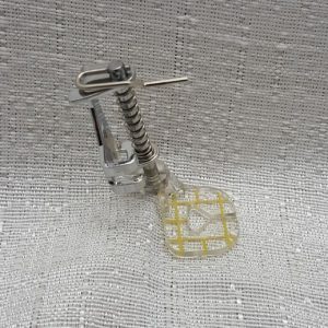 A plastic part for a sewing machine