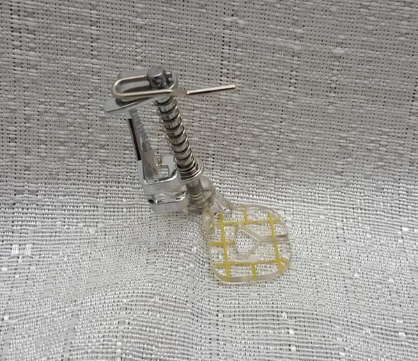A plastic part for a sewing machine
